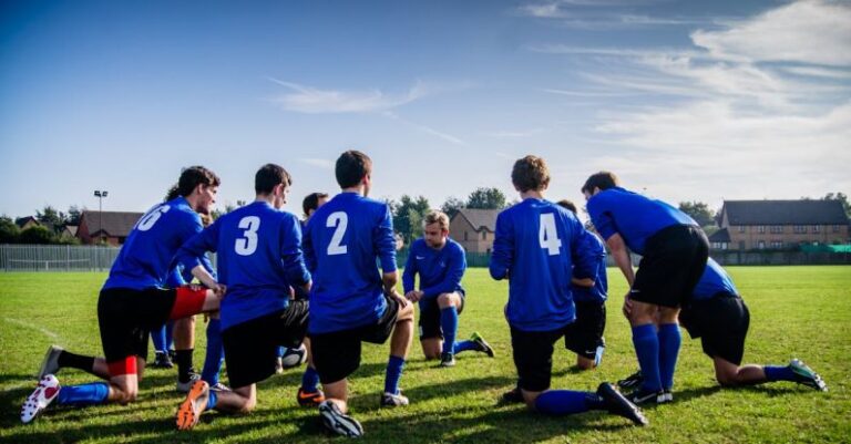 Team Sports - Group of Sports Player Kneeling on Field