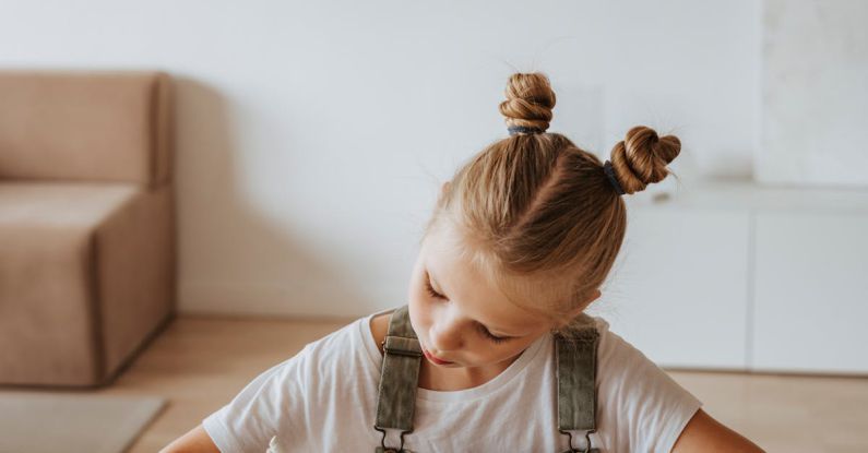 Online Learning - Little Girl Writing on a Notebook