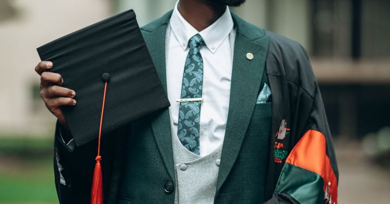 Bilingual Education - A young man in a suit and tie holding a diploma