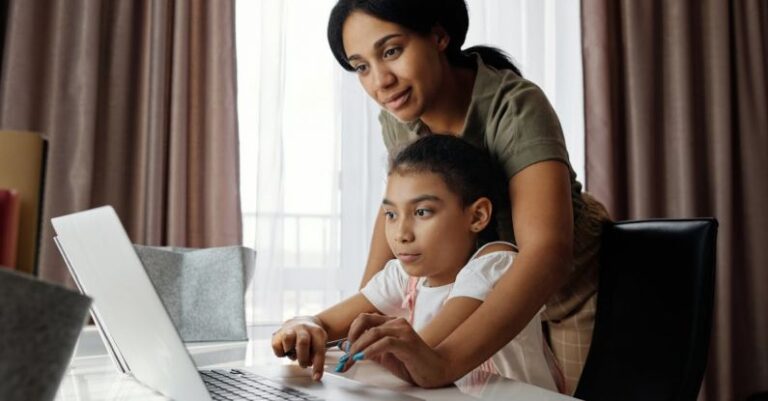 Remote Learning - Mother Helping her Daughter use a Laptop