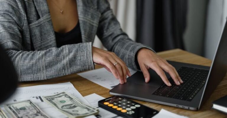 Salary Negotiation - A Woman in Plaid Blazer Using Her Laptop