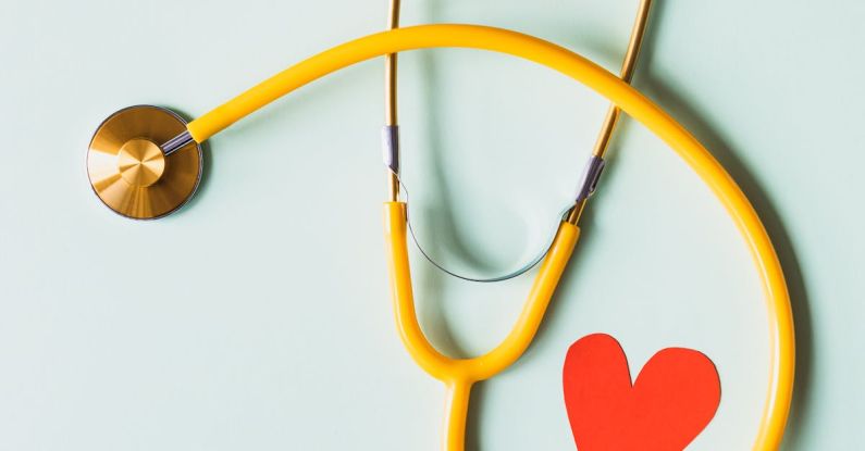 Personalized Medicine - Medical stethoscope with red paper heart on white surface