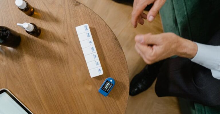 Chronic Disease - Elderly Man Sitting on a Couch and Medicine and Pills on a Table