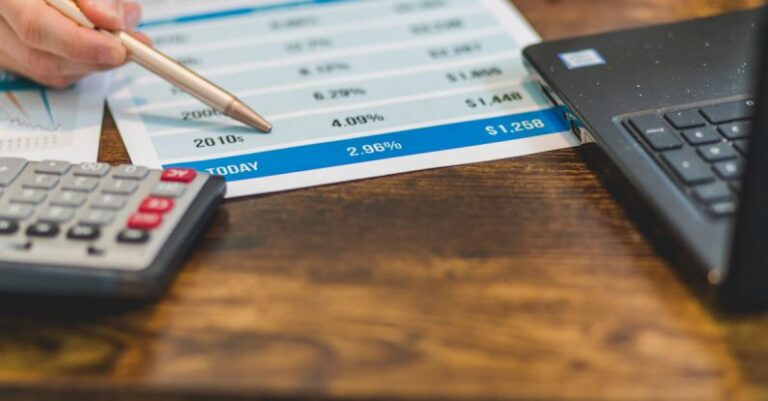 Interest Rates - A Close-Up Shot of an Agent Pointing Rates with a Ballpen