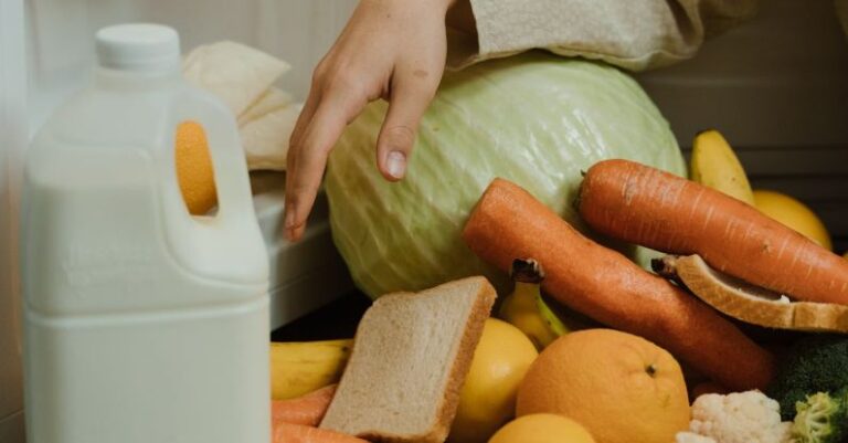 Decluttering - Person Removing Food on the Refrigerator