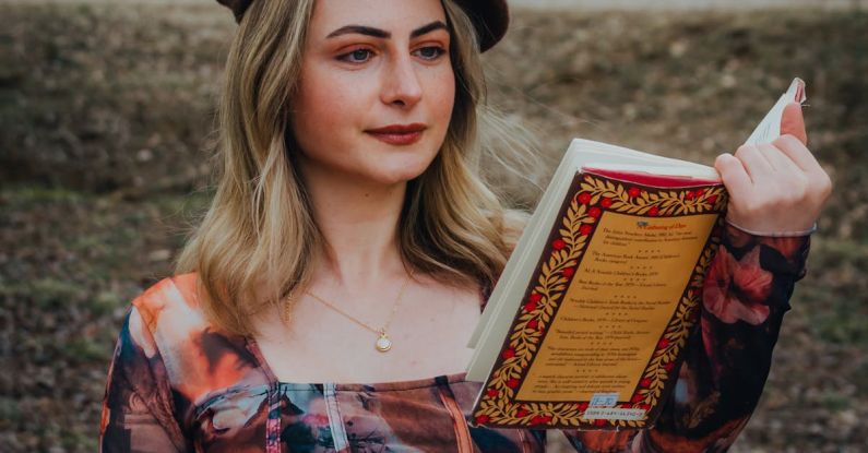 Student Loans - Woman in Beret Reads Book in Park