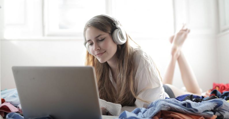 Music Streaming - Woman in White Shirt Using Silver Macbook